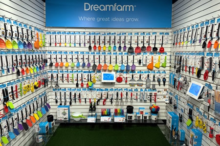 Dreamfarm kitchen gadgets in bright colors displayed on a branded retail wall