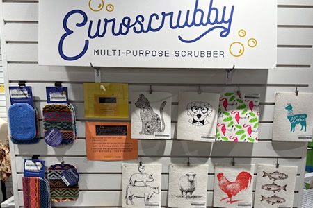 Euroscrubby multi-purpose scrubbers with animal and kitchen designs on a store display wall